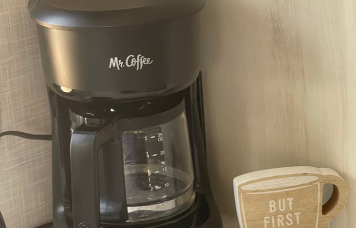 Coffee station equipped with coffee, sugar and sometimes creamer.