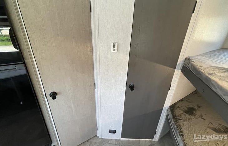 Left door is the pantry and the right door leads to the bathroom.