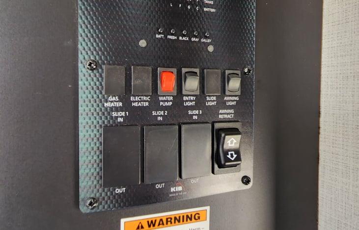 Switchboard. Awning switches, entry light, and water pump found here.