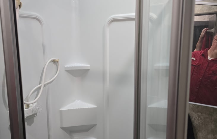 Shower with glass enclosure.