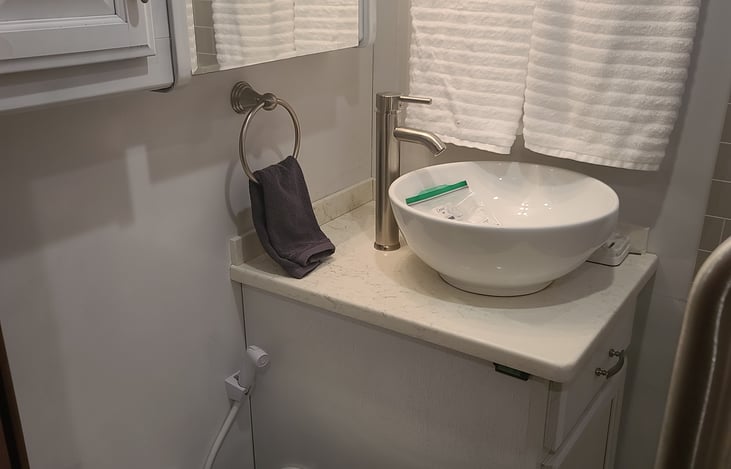 Remodeled vanity with vessel sink.