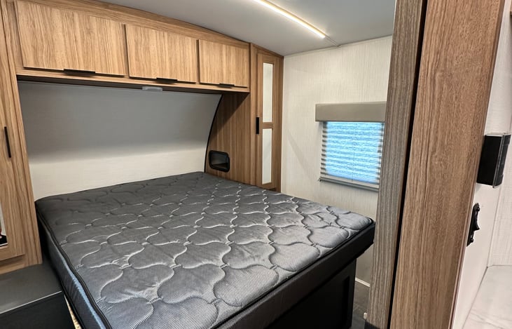 Bedroom with Q size bed and lots of storage