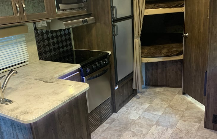 3 burner range, double sink, microwave, oven, fridge/freezer