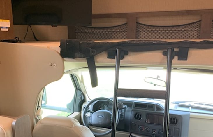 Overhead bunk with compartments. Television can be moved. No more than 700 pounds.