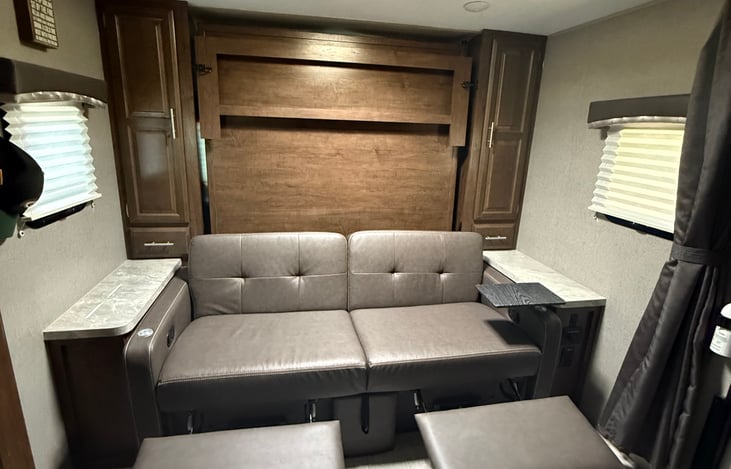 Pop out foot rests from sofa with detachable tables from the arm rests on both sides (only one is pictured)