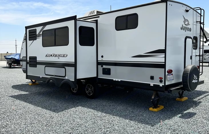 The drivers side pop out for a roomy dining room inside. all attaching water hoses, sewer hose and outdoor shower hose.