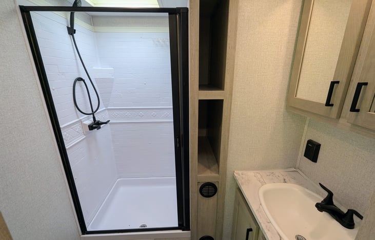 Spacious bathroom with shower and toilet.