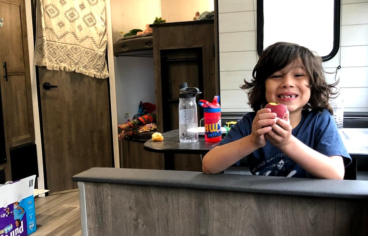 Spacious interior with table, and couch.