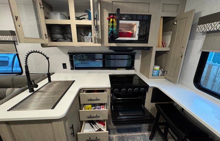 Microwave and oven with plenty of preparation space.