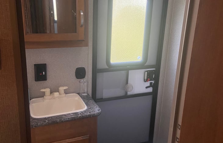 Secondary access into the bathroom from outside allows for you to be able to use the restroom without having to go in and walk through the camper.