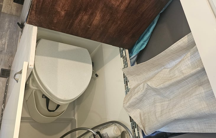 Bathroom under cabinet.  Has shower and composting toilet.