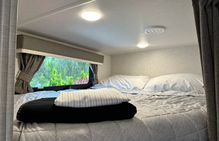 Top Bunk bed with sheets, pillows, throw and blanket for your comfort