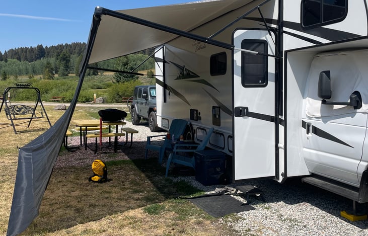 The outdoor living room with some shade under the awning. The awning is push button use.
