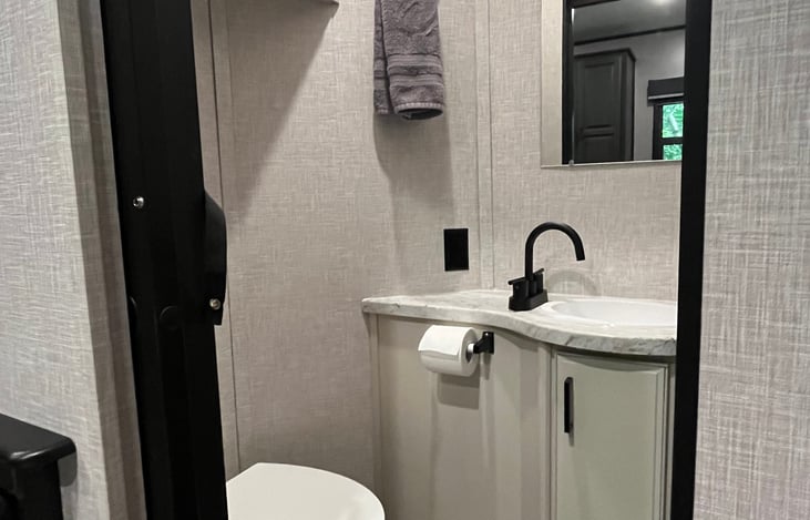 Half bath in bunk house with an exterior exit for easy access to the restroom while spending time in the great outdoors.