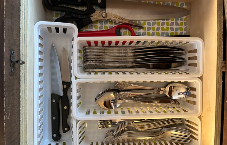 Silverware and a large variety of kitchen utensils.