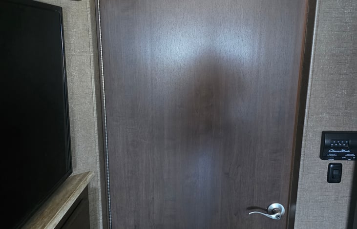 Bathroom door opens to create privacy divider for people taking a shower. This is a rare configuration and is absolutely invaluable for people who appreciate their privacy.