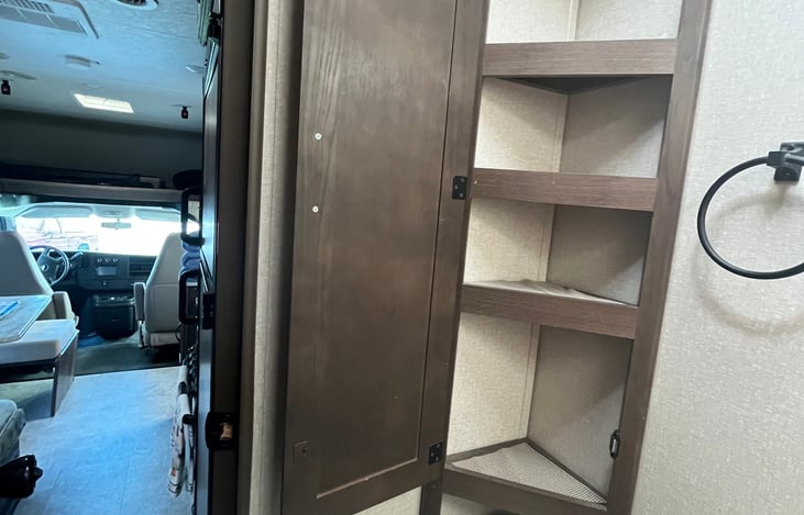 Plenty of bathroom storage above the toilet.