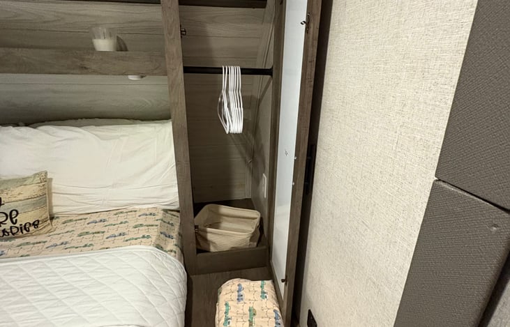 Master bedroom closet one on each side holds several clothing items comfortably