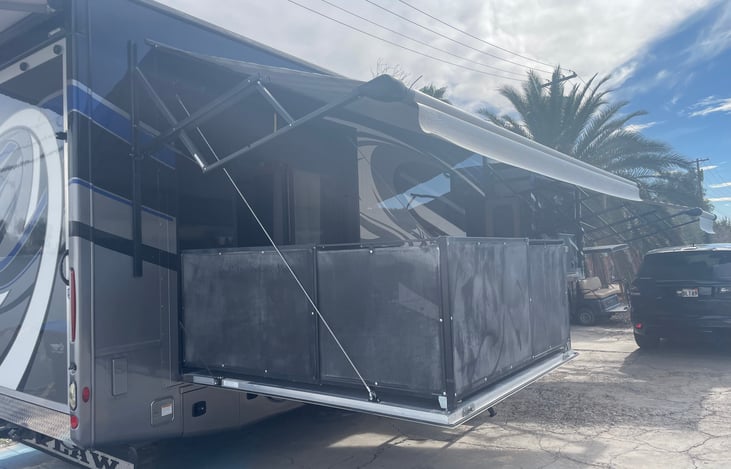 Side patio and retractable, motorized awning.