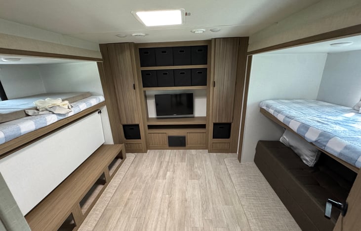 Bunkhouse has three single bunks and a pull out sofa.  Lots of storage and tv.  Perfect place for the kids to have their own space.