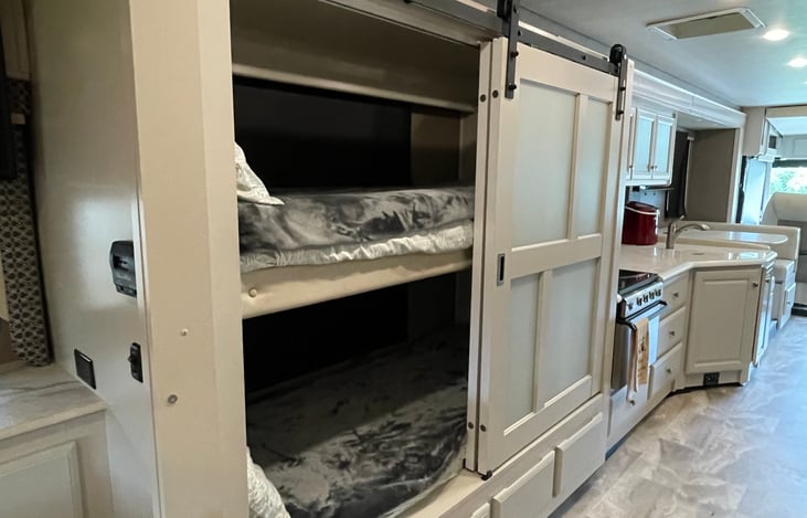 Kids love having a space of their own! Private bunk beds with sliding barn doors create the perfect hideaway for young adventurers