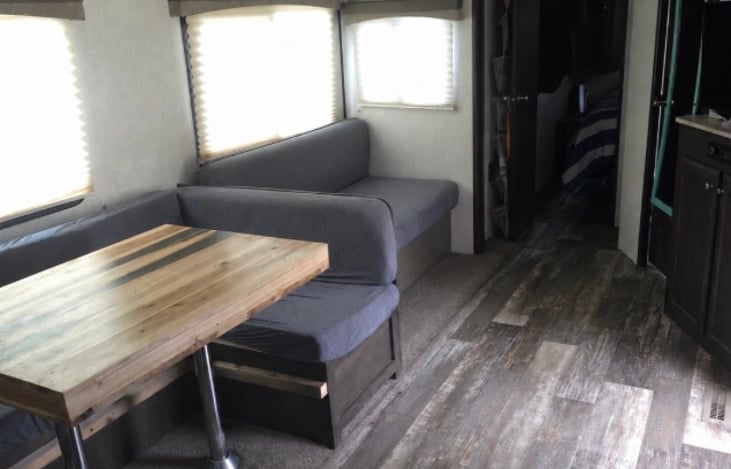 Dinette breaks down into full bed, and couch folds down to single bed.