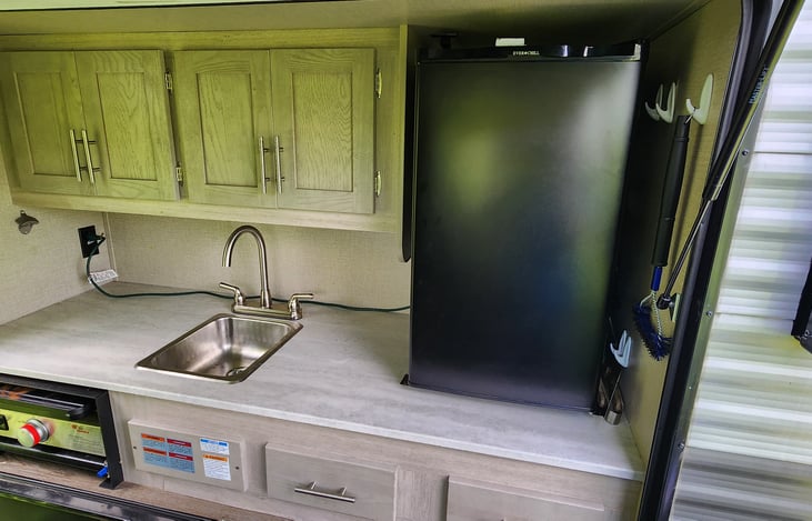 Outdoor kitchen area with griddle and sink to wash your hands.  Not great size for the dishes but inside has a double sink.