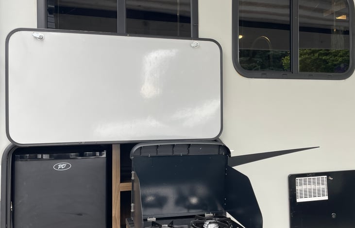 Outdoor stove and refrigerator. We love this because we don’t have to go in and out for an ice cold beveridge!