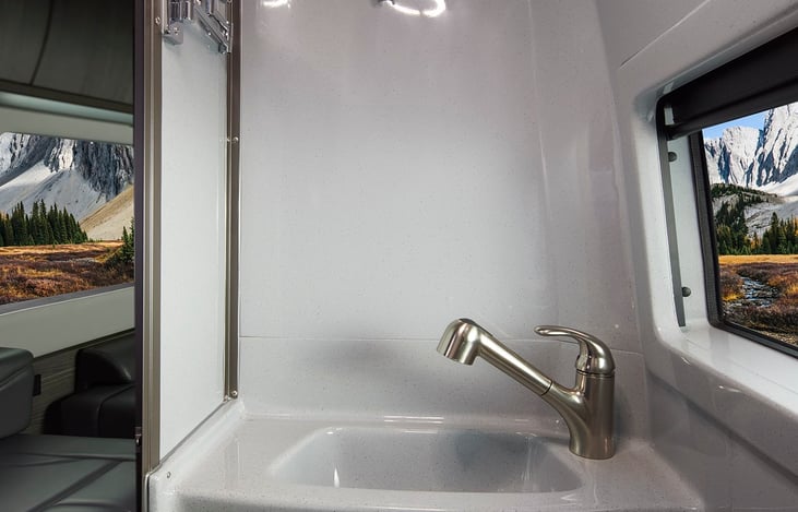 Sin faucet doubles as a shower head, just pull it out nnd place it in the wall bracket.  There's also a telescoping mirror on the bathroom wall and a full length mirror on the bathroom door.