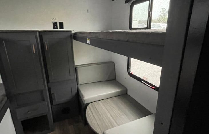 Bunk room (4) twin bunks or (3) bunks and dinette. Has closet and drawers. Pillow, linens, blanket included. Private door to close off. Perfect for children. Weight limit 225 lbs. Toddler rail for 1