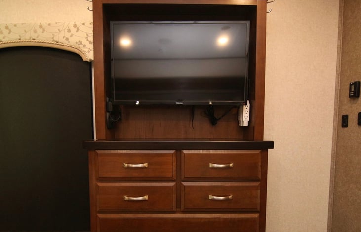 Master bedroom entertainment hutch and dresser.