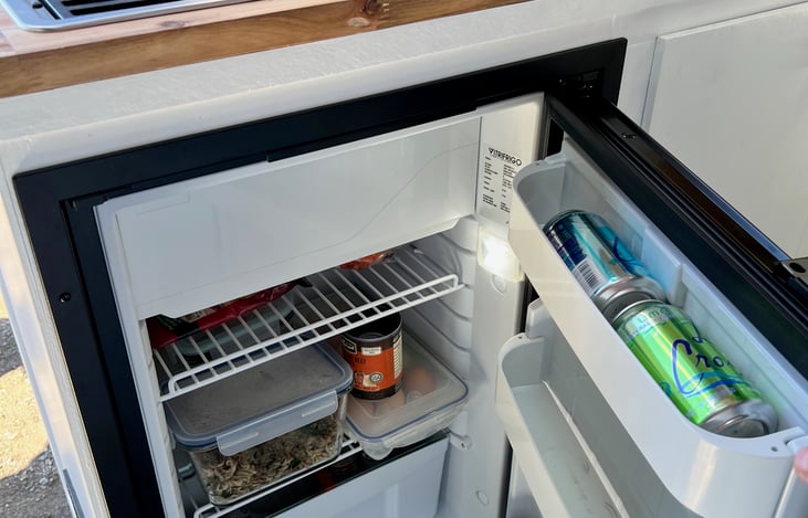 The roomy fridge has space for several days worth of supplies. With the freezer compartment you can enjoy ice cream off grid! Cool!