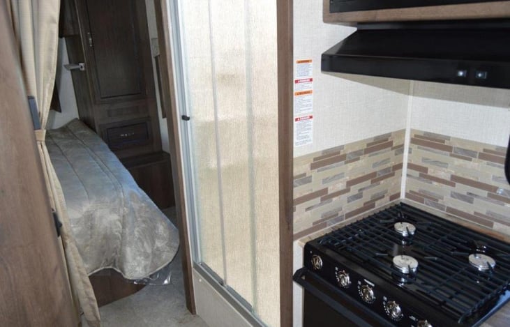 Shower, and stove with microwave.