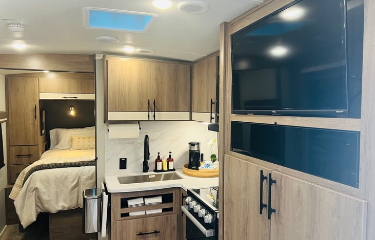 Entertainment Center and Pantry across from Dinette with TV, surround sound, interior and exterior speakers.