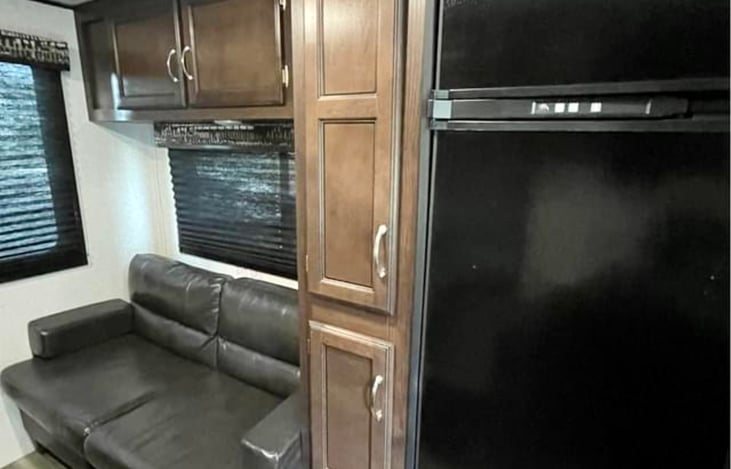 Sleeper sofa with a small amount of underneath storage. 

Large fridge/freezer combo with plenty of adjacent dry-food storage.