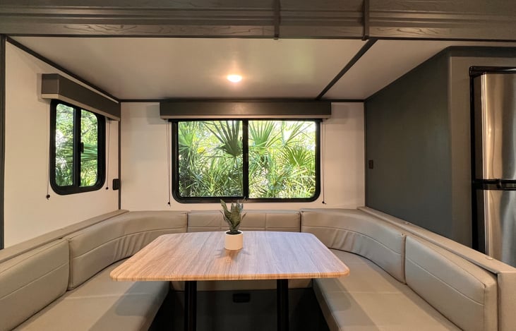 Dinette with residential refrigerator.