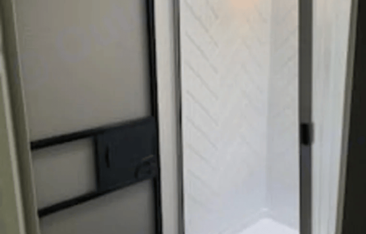 Easy in and out shower with hand wand.  There is also an access door in the bathroom.