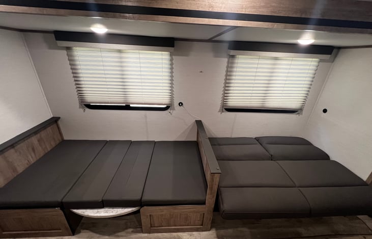 Jack knife couch turned into a bed(right couch). Dinette table turns into bed (left couch).