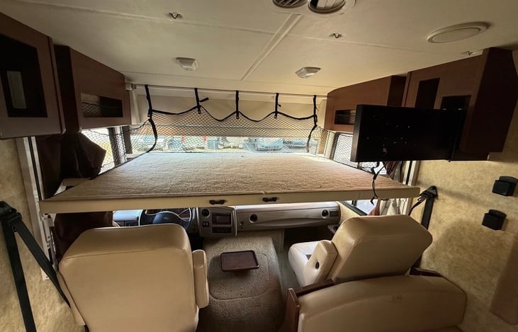 This is the power operated Cab-Over bunk above the driver & passenger seats that easily lowers & raises with the press of a button. Use it as a sleeping area or as a play space for kids.