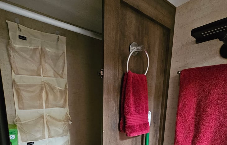 Bathroom includes spacious clothes closet and hangers.