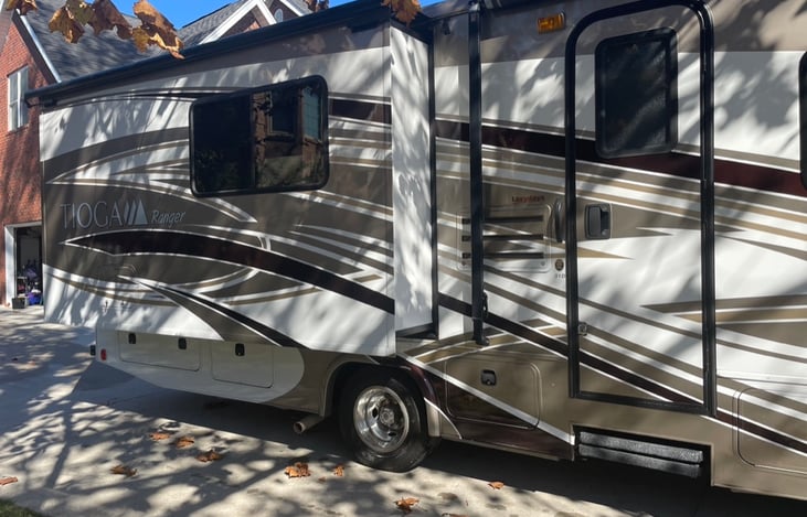 Passenger side slide-out extended. The steps will automatically extend when the door is opened. They can be left open with a support when you're sitting still.