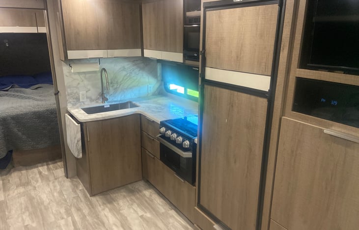 Full kitchen with stove, microwave, refrigerator