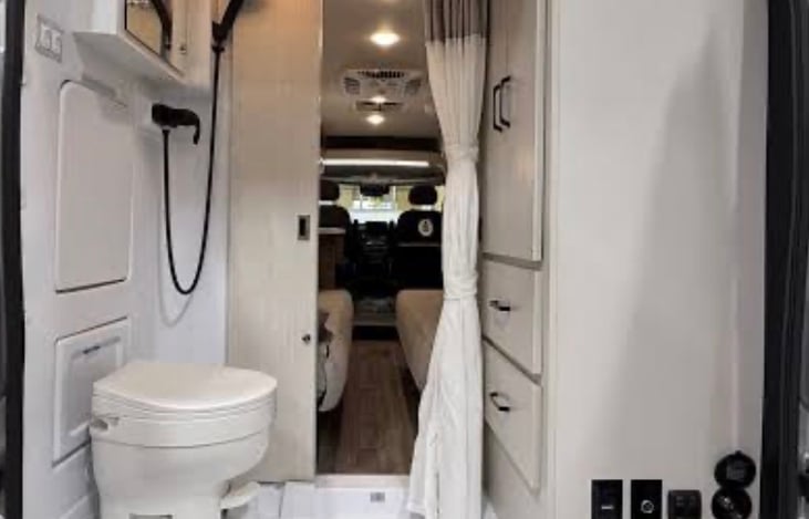 Bathroom with vanity & Mirror, Closet and drawers for clothing and bath Towels.