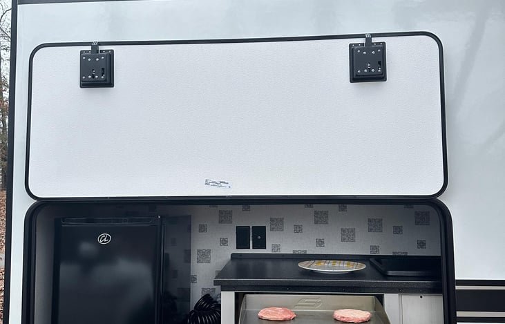 Outdoor grill and mini refrigerator.