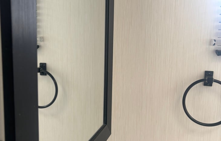 Bathroom mirror with storage behind.