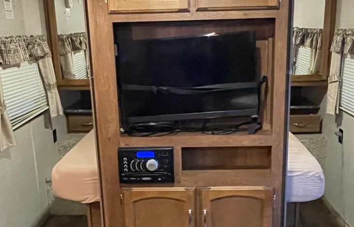 Entertainment center (TV, DVD, Radio) and access to queen size bed (pull out walls for privacy)