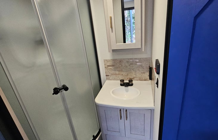 Compact sink with mirrored medicine cabinet — stylish and practical storage for your essentials
