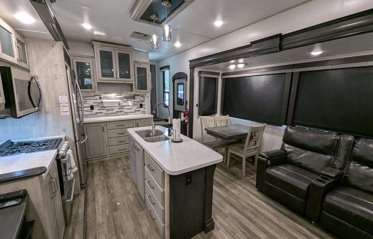 Chef’s dream galley! Features a massive 18 cu. ft. fridge, residential microwave, and 3-burner stove. Enjoy the solid-surface islands, deep sink, and pantry—perfect for feeding the whole crew.