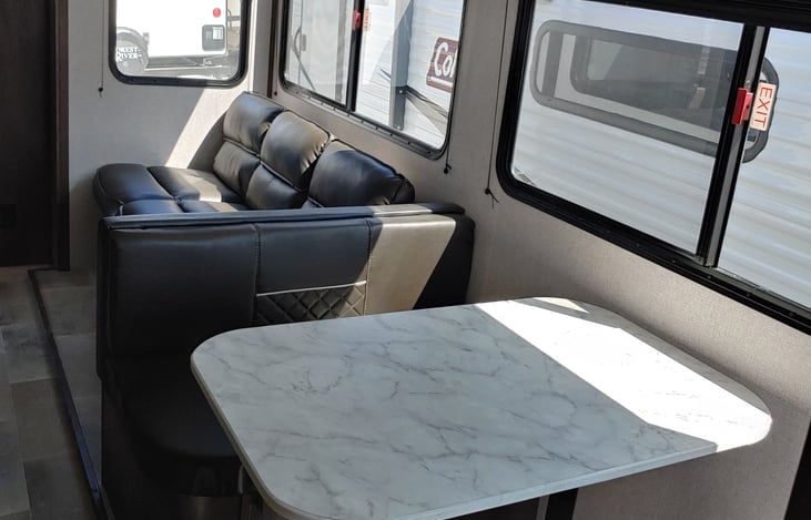 The versatile sofa bed and dinette can easily transform into comfortable sleeping areas for four people.