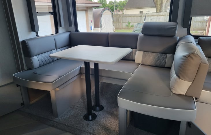 Kitchen table are with storage doors open